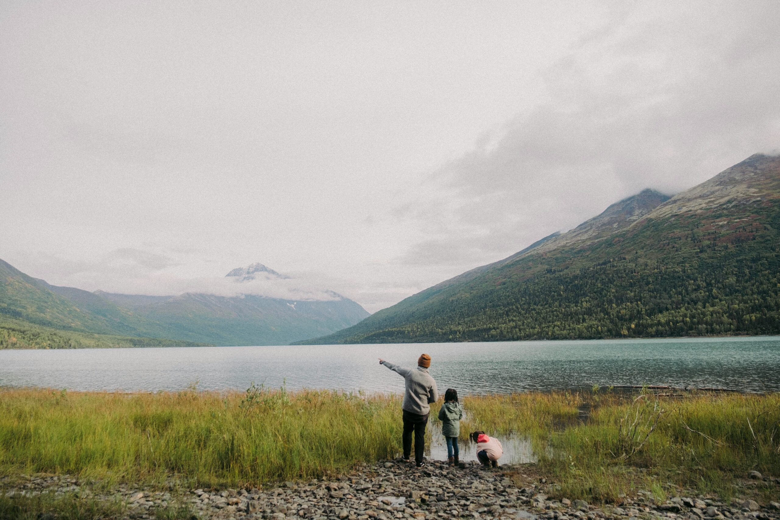 A family around a mountain lake.