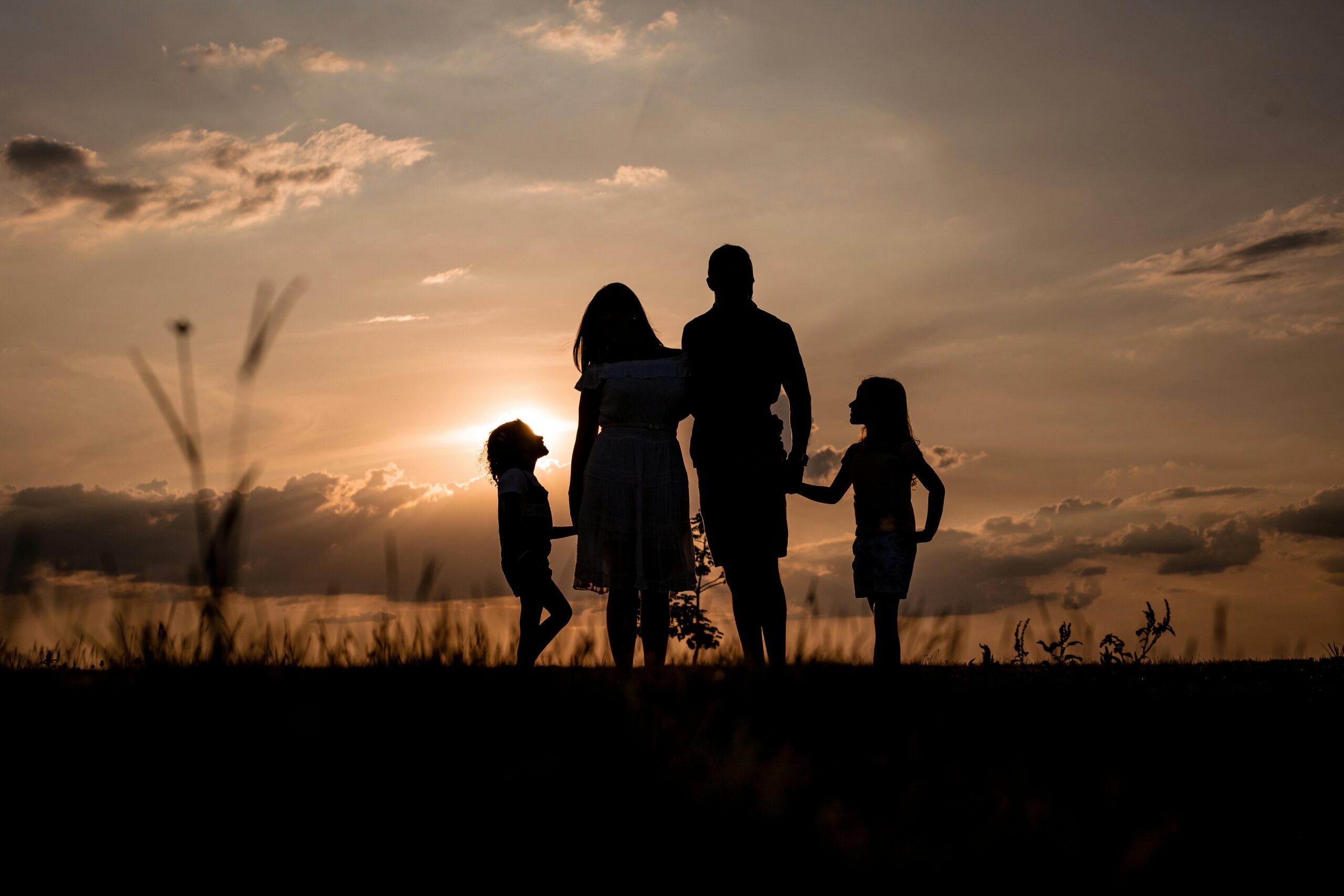 A family outside at sunset.