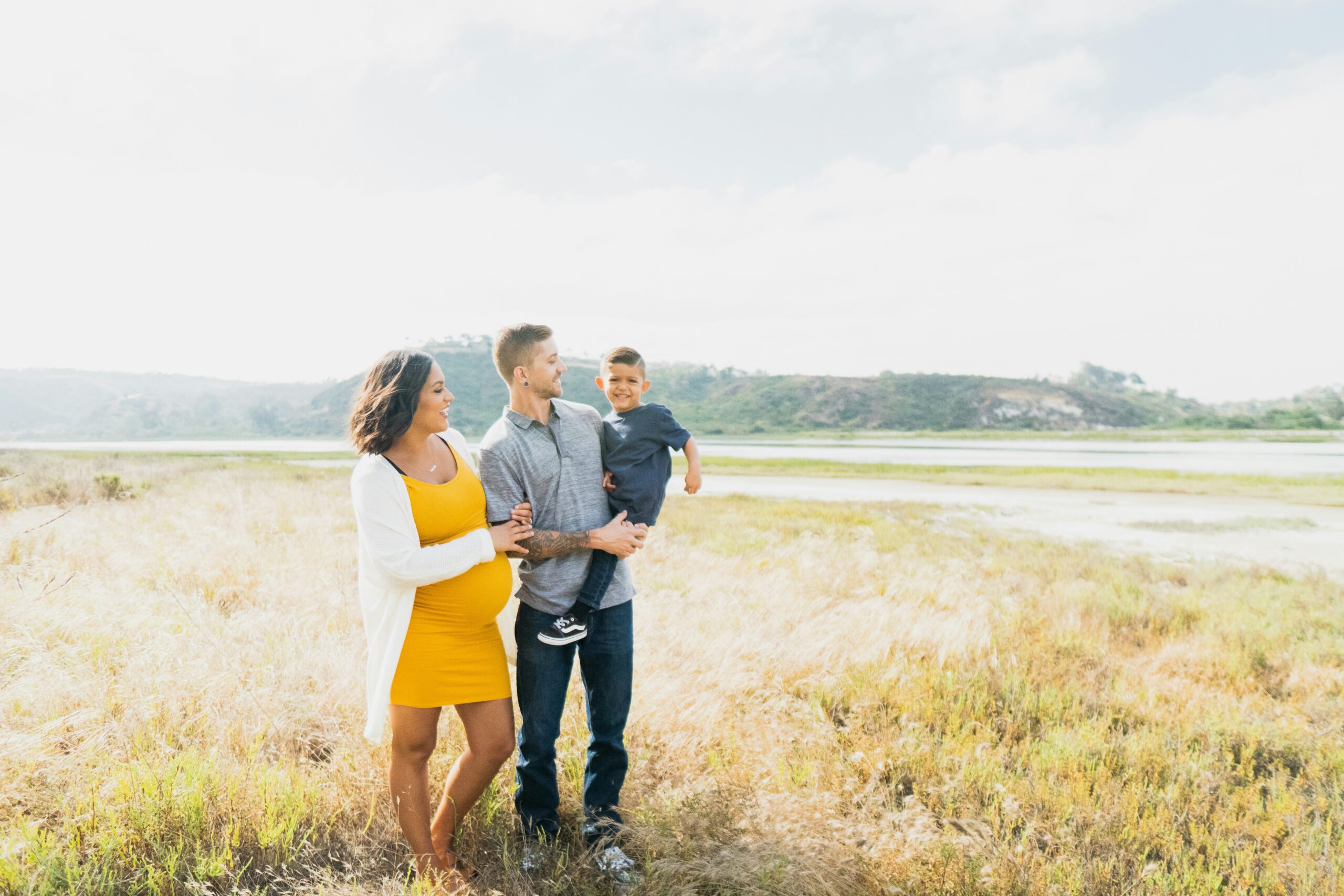 A young family in a field.