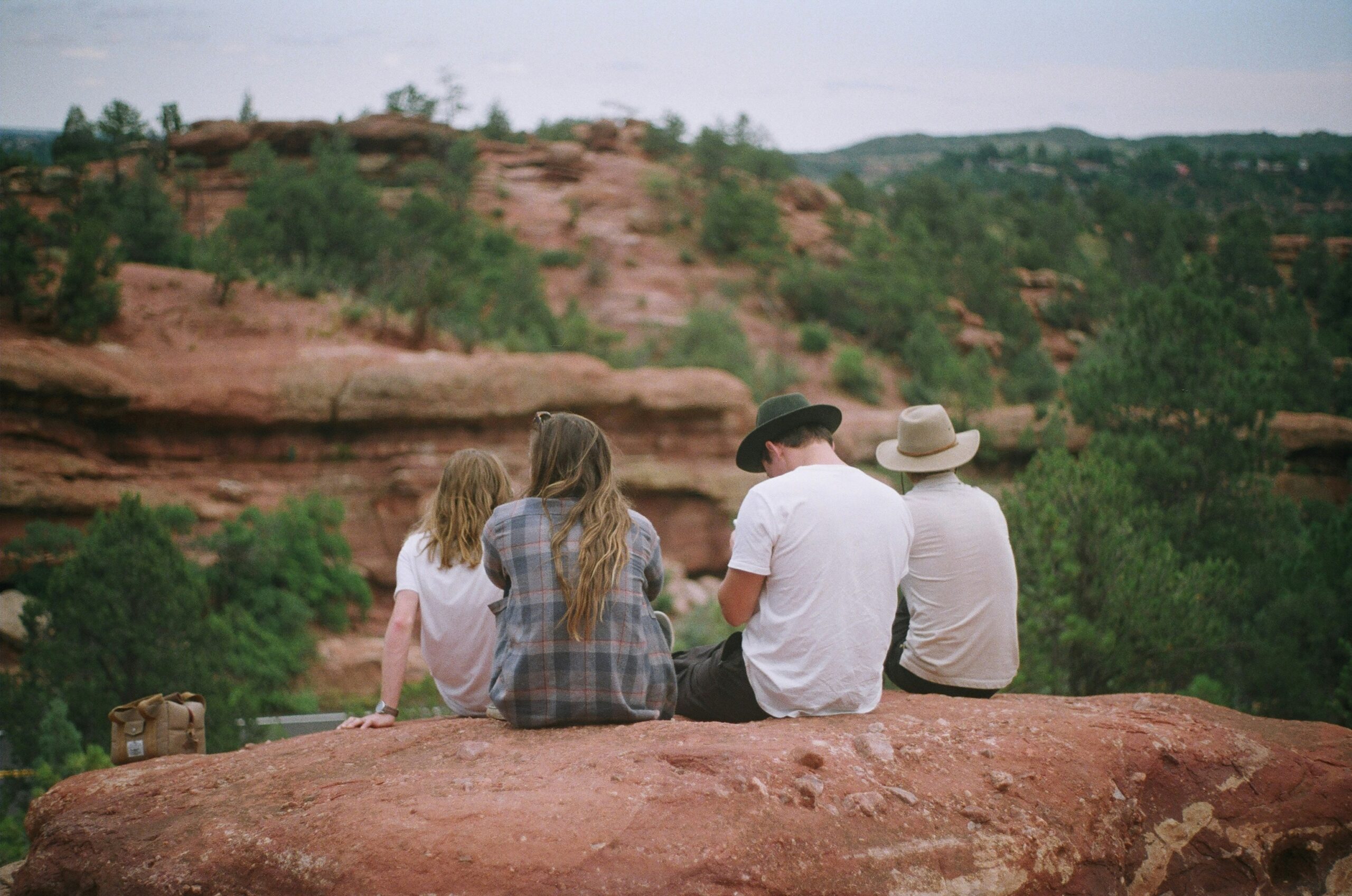 A family sits in the mountains.