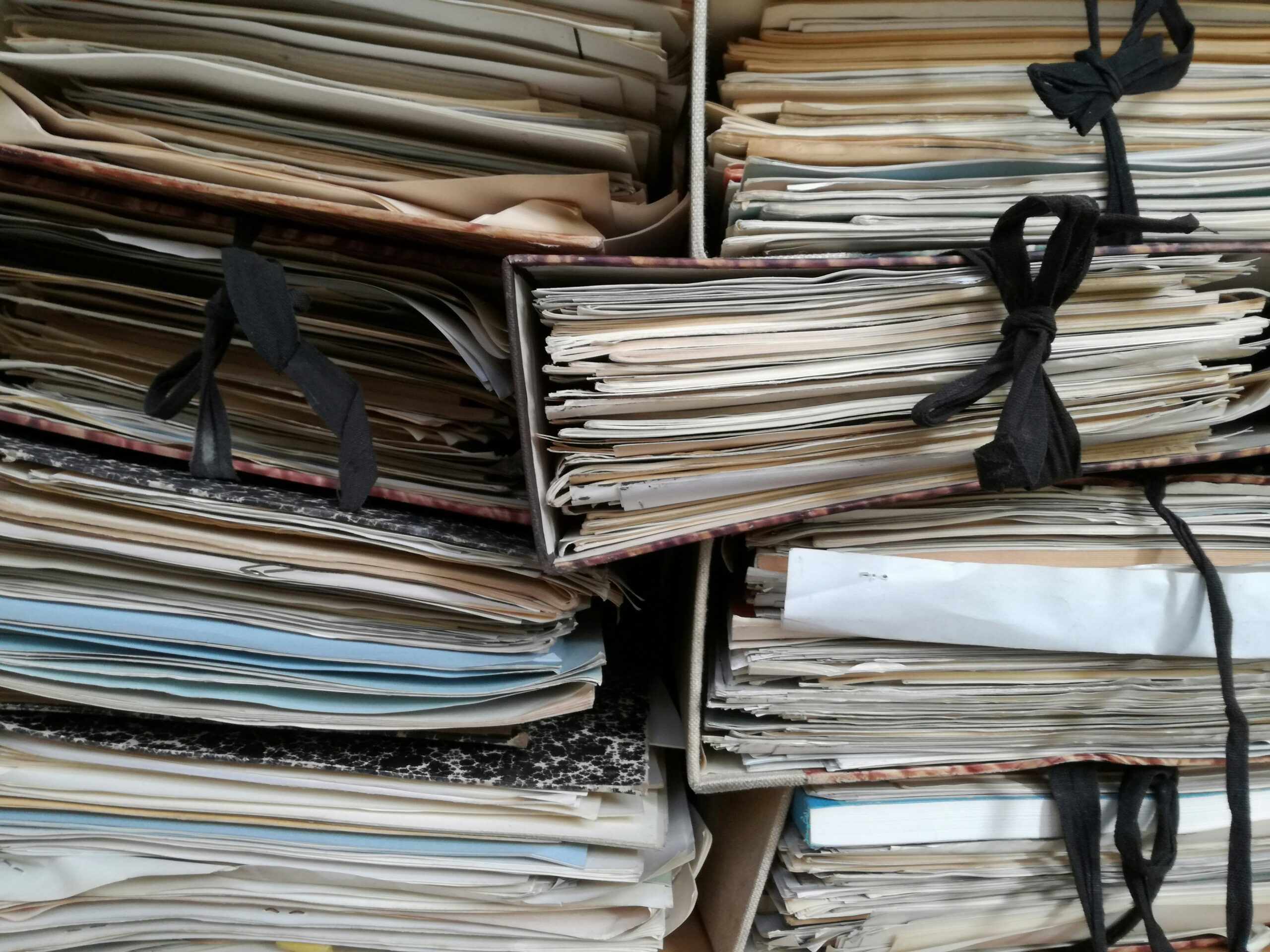 Stacks of binders full of papers.